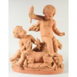 A GOOD LATE 19TH CENTURY TERRA COTTA GROUP, depicting two children tormenting a dog, holding a