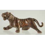 A SMALL JAPANESE BRONZE TIGER. 3ins long.