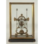 A GROSSHOPPER BRASS AND WHITE ENAMEL SKELETON CLOCK. 14ins high in a glass cover.