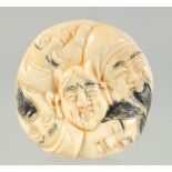 A CARVED BONE FACES NETSUKE. 3.5cm