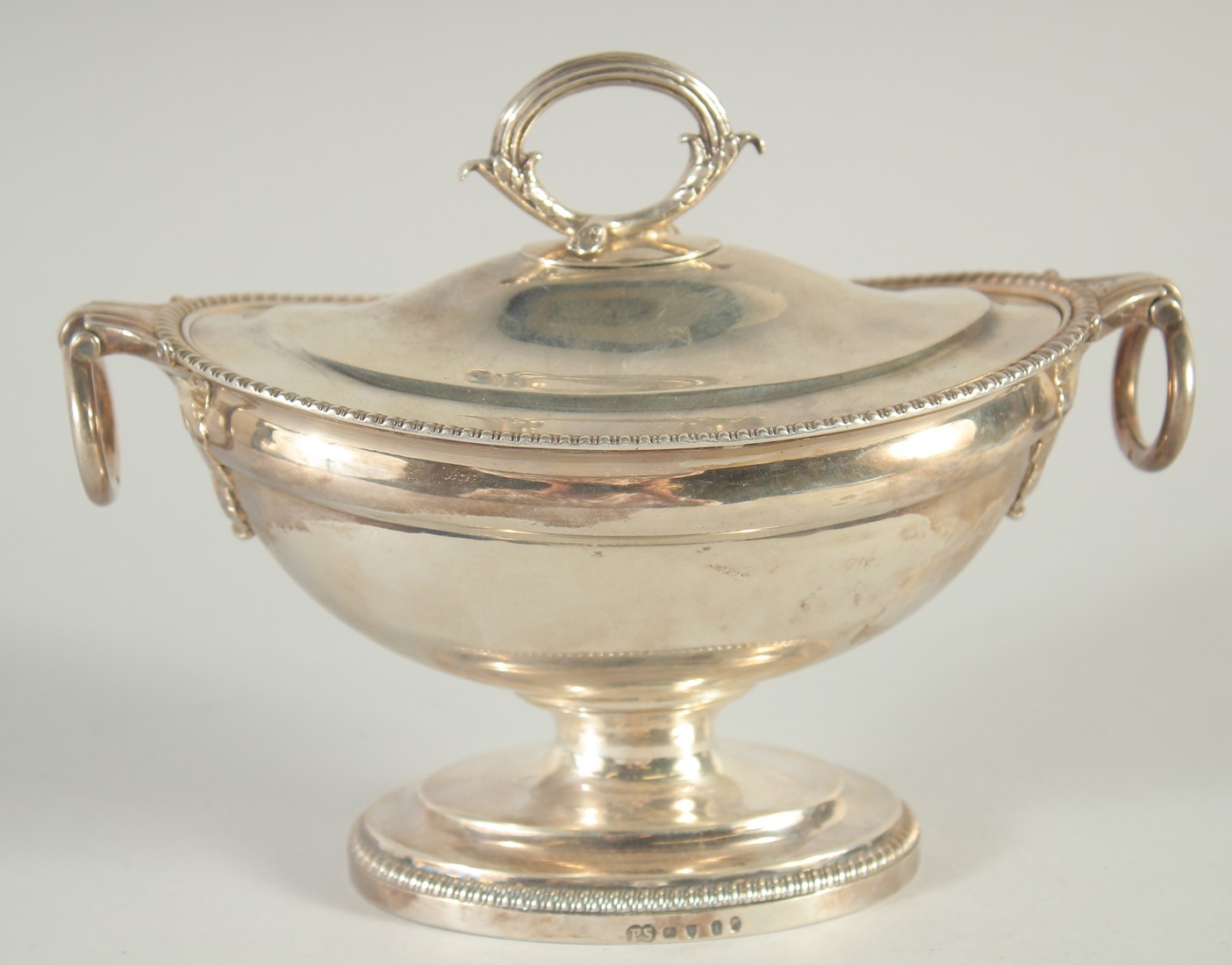 A GEORGE III OVAL SILVER SAUCE TUREEN AND COVER by PAUL STORR with gadrooned edges and ring handles.