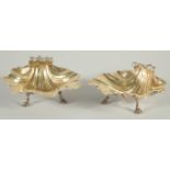 A GOOD PAIR OF VICTORIAN SILVER SHELL SHAPED BUTTER DISHES gilt interiors on three pad feet. 4ins