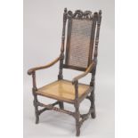 AN 18TH CENTURY OAK ARM CHAIR with cane work back and seat.