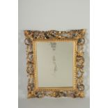 A GOOD 19TH CENTURY ITALIAN CARVED GILTWOOD MIRROR. 19ins x 16ins.
