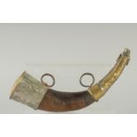 AN EARLY ISLAMIC HORN AND BRASS MOUNTED POWDER FLASK. 11ins long.