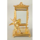 A GOOD GILT BRONZE CUPID before a mirror. 9ins high.