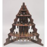 AN UNUSUAL 19TH CENTURY PINE CORNER SPOON RACK, comprising three tiers, each holding numerous carved