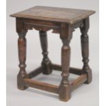 AN 18TH CENTURY OAK JOINT STOOL, with rectangular top, turned leg and a plain uniting stretchers.