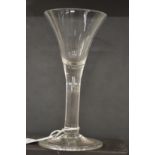 AN 18TH CENTURY ENGLISH WINE GLASS with tapering bowl.
