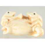 A CARVED BONE GROUP OF TWO FROGS. 1.75ins.