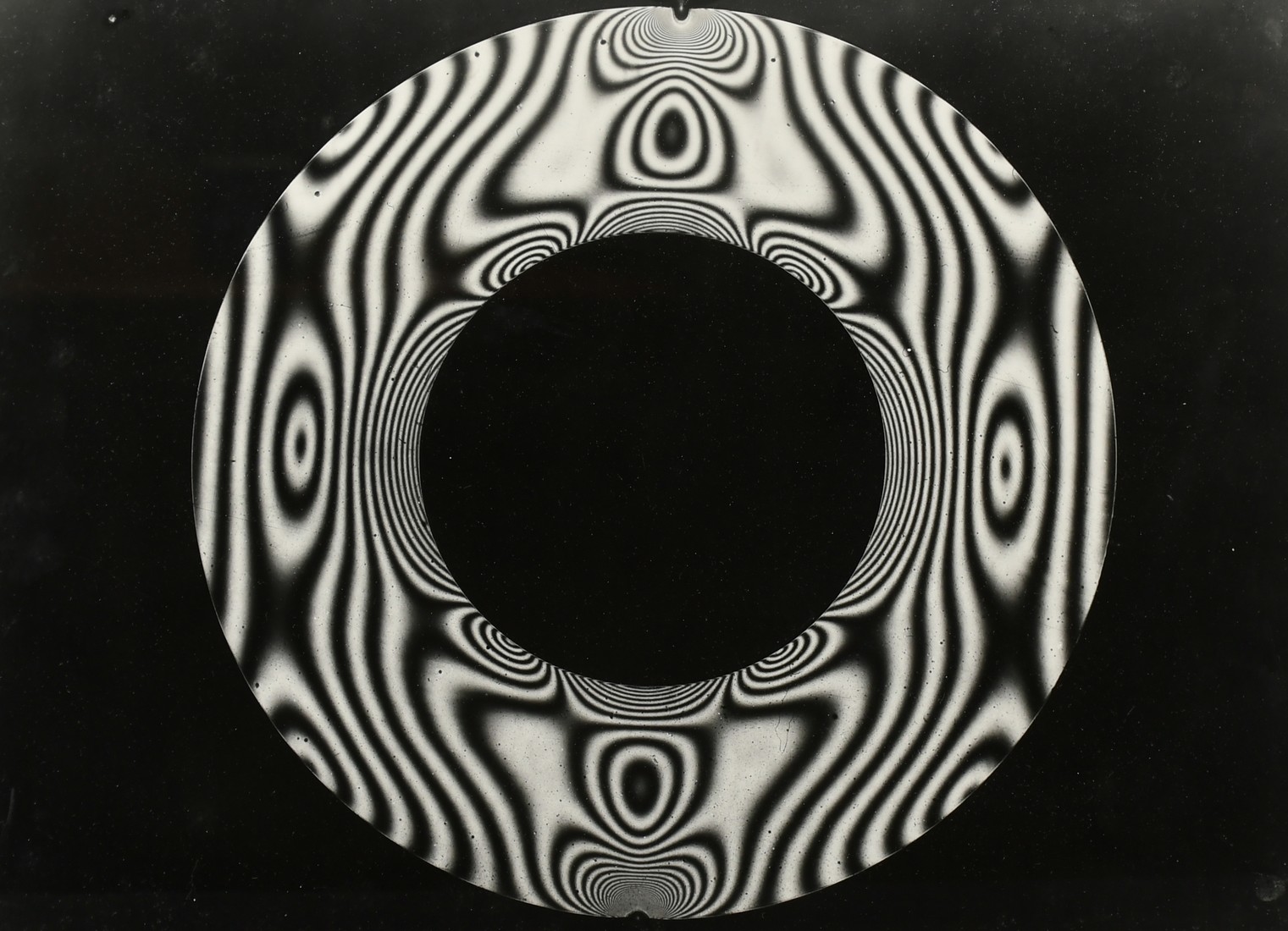 Circa 1960's, a collection of three black and white photos of psychedelic subjects, each around