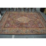 A large Persian style rug with all over floral decoration 285cm x 210cm.