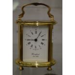 A brass carriage clock.