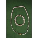 A pearl necklace and bracelet.