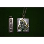 A silver and enamel pendant and chain and a silver Hallmark pendant.