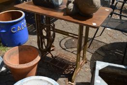 A Singer treadle sewing machine converted to a garden table.