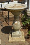 A classical baluster shaped composite garden bird bath.