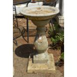 A classical baluster shaped composite garden bird bath.