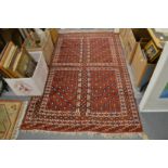 Persian rug, red ground with stylised decoration 200cm x 130cm.