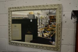 A decoratively framed mirror.