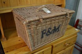 A Fortnum and Mason's wicker hamper (lacking contents).