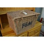 A Fortnum and Mason's wicker hamper (lacking contents).