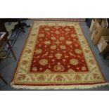 Modern carpet, red ground with stylised floral and leaf decoration 250cm x 170cm.