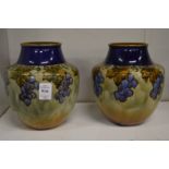 A pair of Royal Doulton vases with grape and vine decoration.