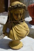 A garden ornament modelled as a bust of the veiled bride.