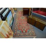 A Persian runner or hall carpet, red ground with stylised decoration 280cm x 100cm.