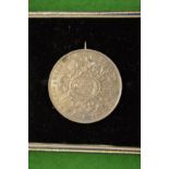 A Mexican one Peso, 1866 mounted as a brooch.