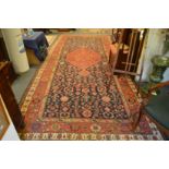 A good early 20th century Persian carpet, blue ground with stylised decoration 500cm x 210cm.