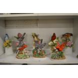 A collection of porcelain bird ornaments.