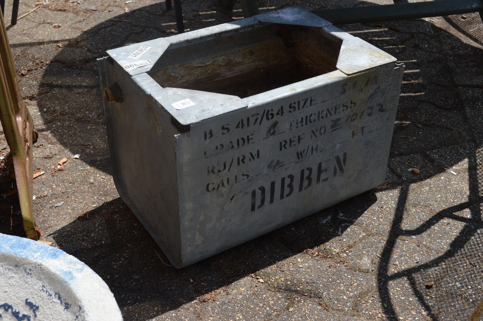 A small galvanized water tank.