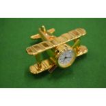 A novelty biplane bedside clock.