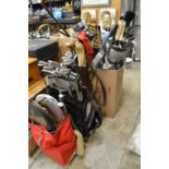 A large quantity of old golf clubs, golf bags, tennis rackets etc.