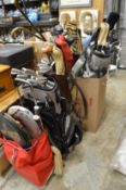 A large quantity of old golf clubs, golf bags, tennis rackets etc.