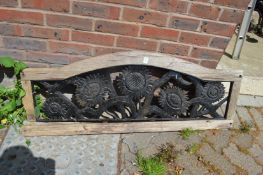 A cast iron and wooden framed garden ornament.