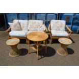 A bamboo conservatory two seater settee with matching armchair together with three wicker tables.