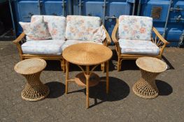 A bamboo conservatory two seater settee with matching armchair together with three wicker tables.