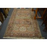 A Turkish part silk carpet with stylised floral decoration 265cm x 145cm.