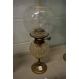 A brass and cut glass oil lamp.