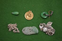 Gold medallion, three jade pieces and two silver brooches.