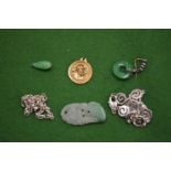 Gold medallion, three jade pieces and two silver brooches.