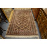 A modern Bokhara style rug, cream ground with stylised decoration 200cm x 130cm.