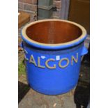 A large glazed pot, embossed Calgon.