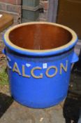 A large glazed pot, embossed Calgon.