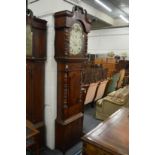 A large 19th century mahogany longcase clock with painted arched dial and moon phase movement.