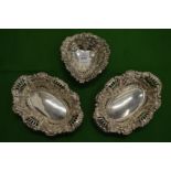 A silver heart shaped bon bon dish and a pair of similar oval dishes.