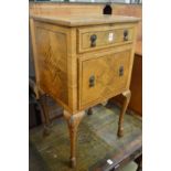 A walnut sewing cabinet.